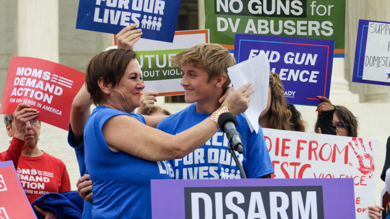 Kate Ranta hugs her son, Will, after he shares his story on the steps of the US Supreme Court.