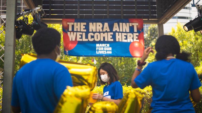 MFOL Houston host event with a banner saying, "THE NRA AIN'T WELCOME HERE" and gold balloons.